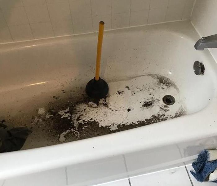 bathtub with dirty scaled residue in it