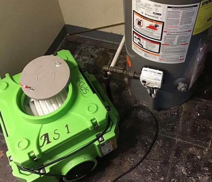 utility room with servpro equipment in place to remediate sewage damage